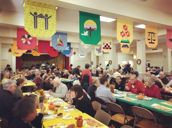 A photo from our Thanksgiving dinner, with hundreds in attendance, eating and making conversation with each other.