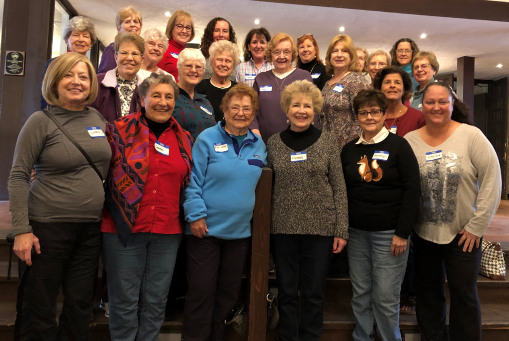 A large group of women, posed and smiling for the camera