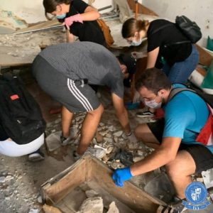 Volunteers clearing rubble from an earthquake